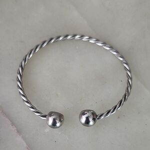 Elegant Silver Toned Twisted Torque Cuff Bracelet With Ball Ends